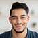 Smiling man with a bright, renovated home background, representing quality home remodeling services.