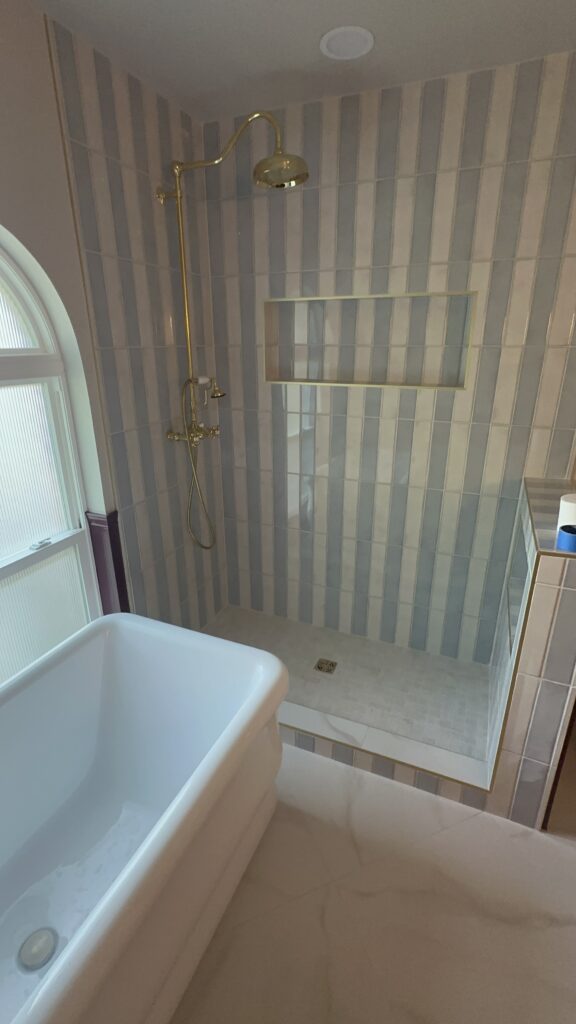 Luxury bathroom shower renovation with custom tile work and premium fixtures.
