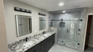 Modern bathroom renovation with double vanity and walk-in shower.
