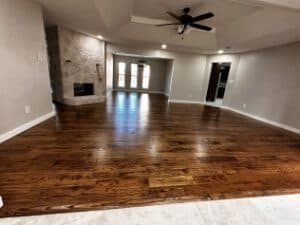 Spacious living room with hardwood flooring, modern design, and natural light features.