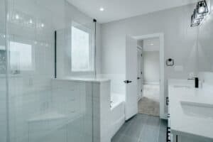 Bright, clean bathroom with white tiles, double sink, and contemporary fixtures.