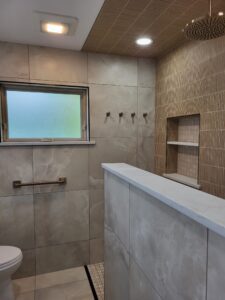 Bright bathroom with contemporary tile work and safety features.