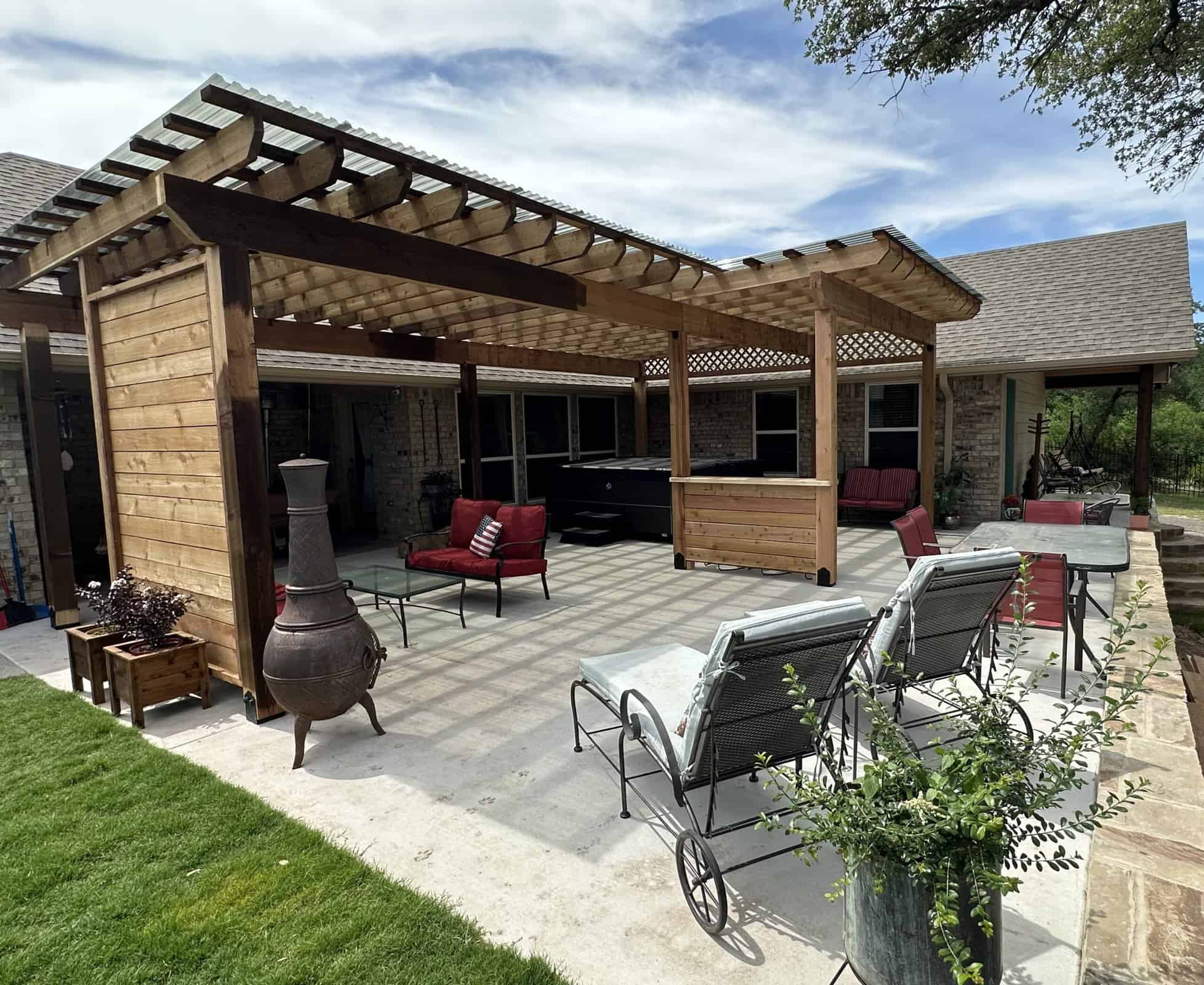 Beautiful backyard patio with wooden pergola, outdoor furniture, and landscaping for home outdoor living enhancement.