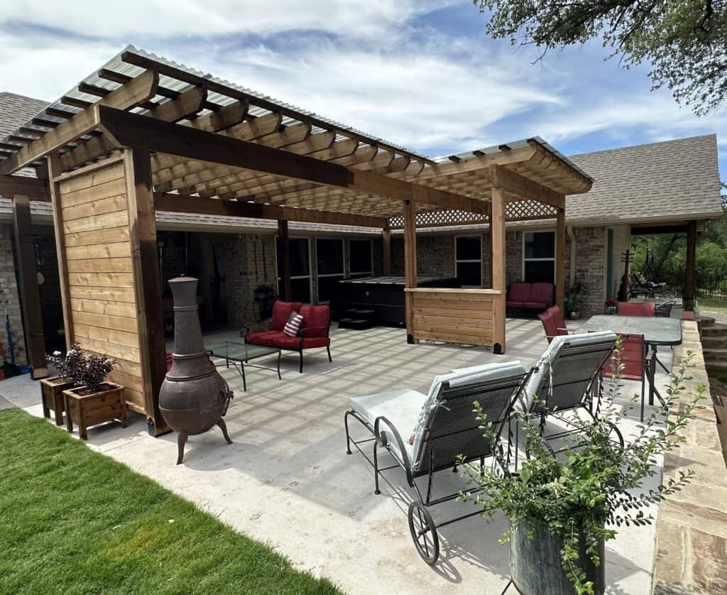 Beautiful backyard patio with custom pergola, outdoor seating, and landscaping by Salvation Home Remodeling.