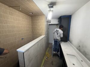 Custom bathroom remodeling by Salvation Home Remodeling showcasing tile, cabinetry, and wall finishing.