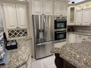 High-quality kitchen renovation featuring stainless steel refrigerator and double oven.