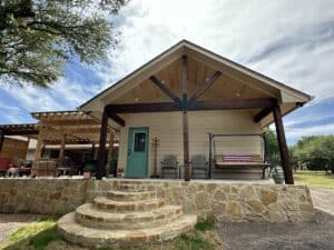Bright outdoor patio featuring stone steps, a cozy swing, and stylish seating area for outdoor relaxation.