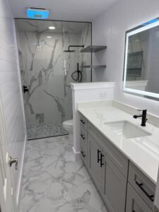 Bright, modern bathroom with marble accents and sleek fixtures. Perfect for contemporary remodeling projects.