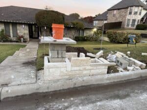 Close-up of brick mailbox being built in front yard, home renovation project underway.