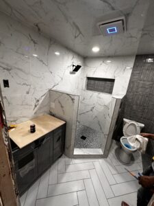 Luxurious marble bathroom with walk-in shower, contemporary fixtures, and stylish tiles.