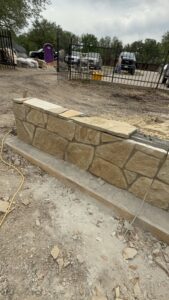 Durable stone wall for residential outdoor remodeling projects by Salvation Home Remodeling.