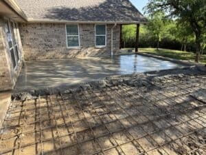 A newly poured concrete patio with strong rebar reinforcement, perfect for outdoor living and home improvement projects.