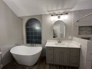 Bright, contemporary bathroom featuring a freestanding tub, sleek vanity, and elegant marble tiles.