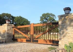 Beautiful wooden gate with stone pillars at Salvation Home Remodeling. Expert home renovation and remodeling services.
