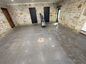 Bright, polished concrete floor with a brick wall backdrop in a remodeled home.