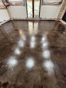 Concrete floor during renovation process in a family living space.