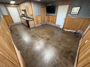 Alt: Beautifully remodeled indoor space with wood paneling, concrete floors, and modern finishes.