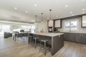 Spacious kitchen with contemporary design, white countertops, and sleek cabinetry for home remodeling.