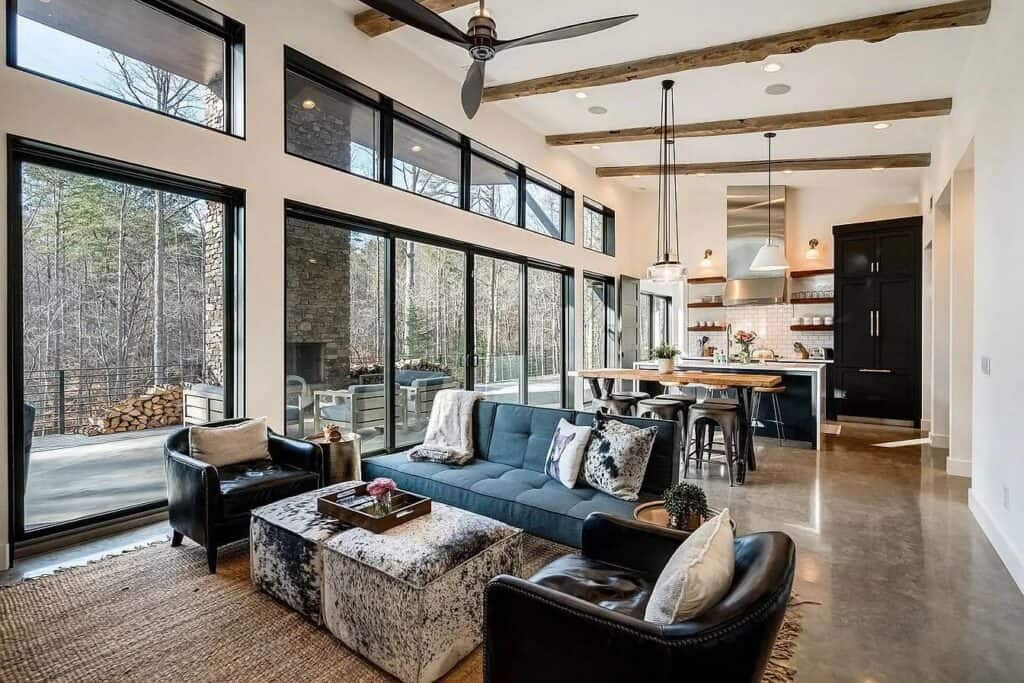 High-resolution modern living room with large windows, open kitchen, and stylish furnishings.