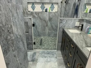 Custom tile walk-in shower with mosaic niche and pebble floor — bathroom remodel by Salvation Home Remodeling