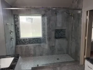 Master bathroom remodel with dual-head tile shower, glass mosaic accent band and hexagon pebble floor — Salvation Home Remodeling