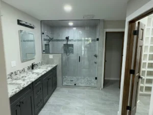 Master bathroom remodel with frameless walk-in shower and granite-top vanity — Salvation Home Remodeling