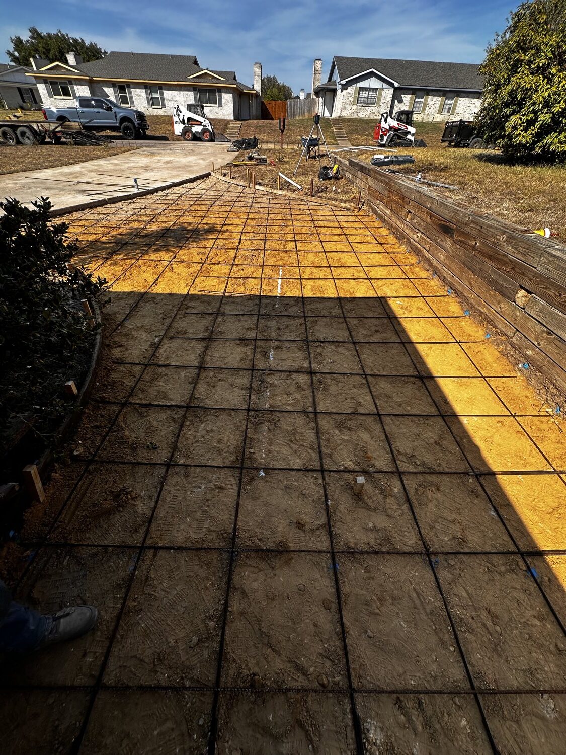 Rebar grid tied and chaired on a prepped base before a concrete driveway pour in Fort Worth.