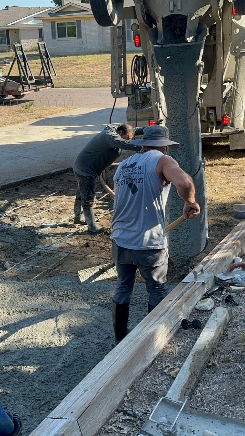 Crew placing concrete at the truck chute during a Fort Worth driveway pour.