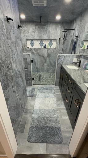 Grey marble walk-in shower with frameless glass, mosaic accent band and a custom vanity in a Fort Worth bathroom remodel.