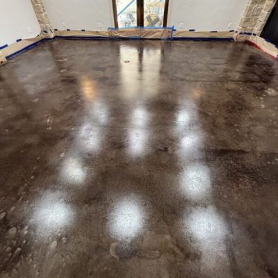 Concrete floor during renovation process in a family living space.